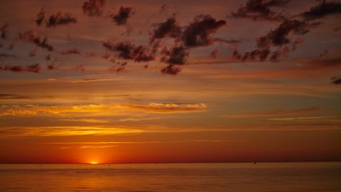 a sunset over a body of water