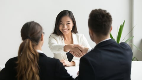 woman shaking hands with hiring manager