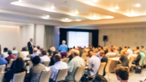 a group of people in a hotel conference room