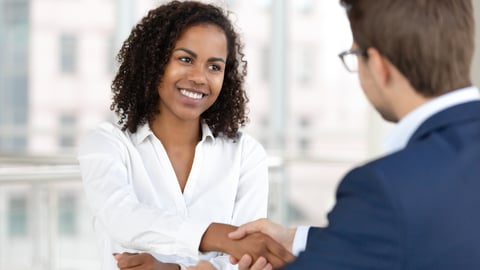 woman shaking hands with hiring manager