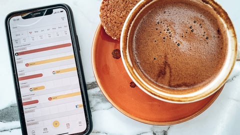 enviivo mobile app next to cup of coffee