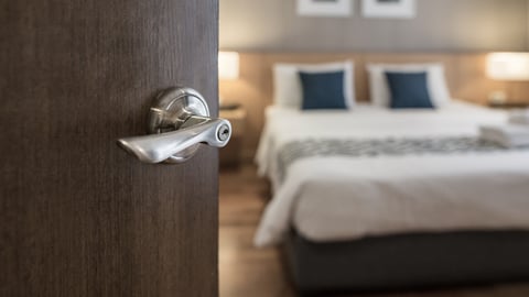 hotel room door and bed shutterstock