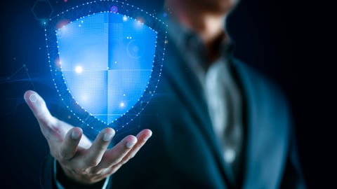 digital blue shield in front of a man in a suit