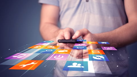 person holding a mobile phone with app icons