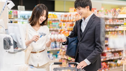 man and woman using self checkout