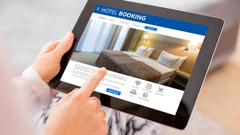 Person booking a hotel room via their tablet