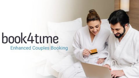 Couple in hotel room booking a spa appointment