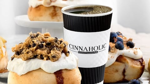 a close up of food on a table next to a cup of coffee