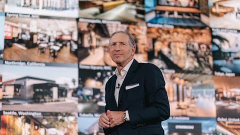 Howard Schultz standing in front of a building