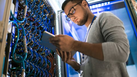 a man standing in front of a computer