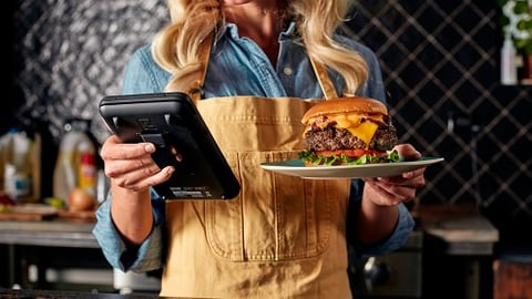 a woman standing in front of a tablet