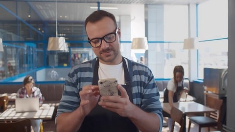 a person sitting at a table eating food