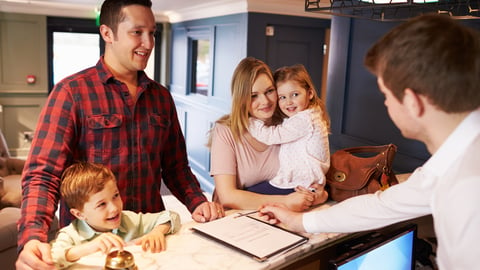 Family check-in at hotel front desk