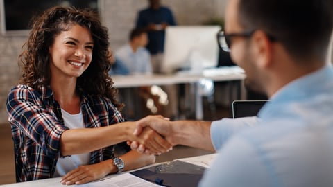 woman shaking a manager's hand