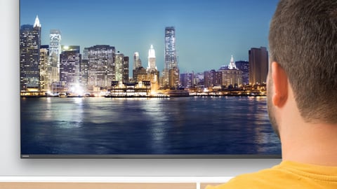 a man looking at a tv