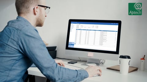 a man standing in front of a computer