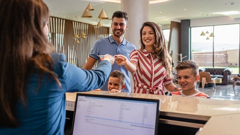 a family checking in at a hotel