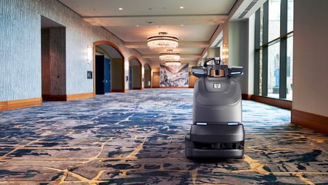 Brain Corp. robotic vacuum in hotel ballroom