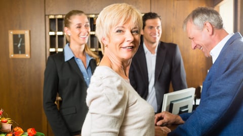 hotel guests checking in at front desk