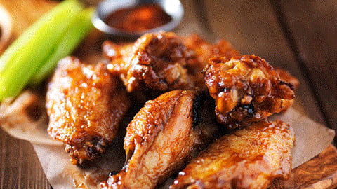 barbecue wings on a plate with celery