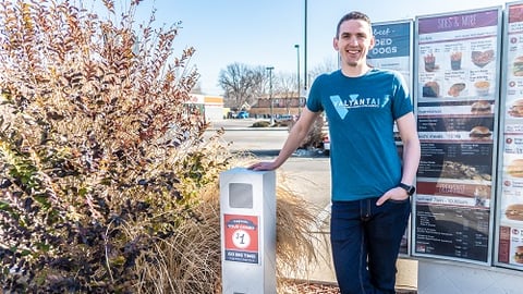 Rob in drive-thru of Good Times in Denver standing in front of menu board