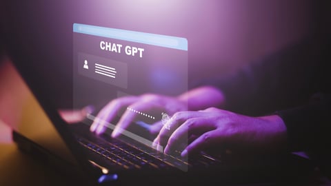 laptop screen showing a person using chat gpt