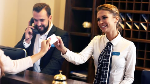 hotel front desk agent accepting card for payment