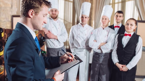 hotel manager talking to staff