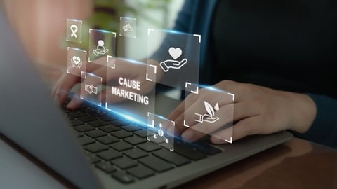 laptop with person working on cause marketing campaign