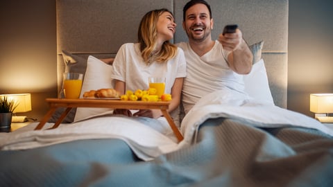 Happy couple having a breakfast in the bed.Romantic moments at home.They are watching tv in bedroom.; Shutterstock ID 1720357981