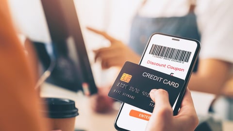 Hand holding credit card payment and using smartphone with scan barcode for discount code coupon, shopping online, Digital wallet concept.; Shutterstock ID 2246986563