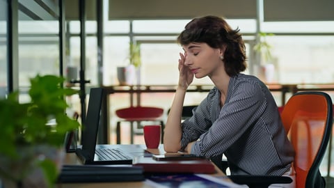 European Caucasian business woman sitting chair feel tired lack of energy indoor job office work place. Young adult gen z exhausted lazy bored female worker lady employee use laptop do over hours work; Shutterstock ID 2471883261