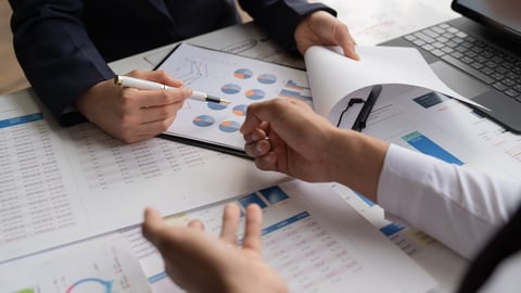 Businessman and woman discussing commercial real estate sector faces risks as financial buy used laptopcalculator and chart in the office.; Shutterstock ID 2497374541