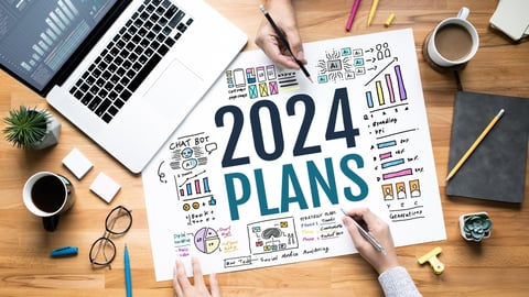 paper on a desk that says 2024 plans