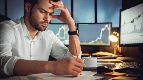 worried executive sitting in front of PC