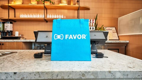 blue bag on a restaurant counter featuring favor logo