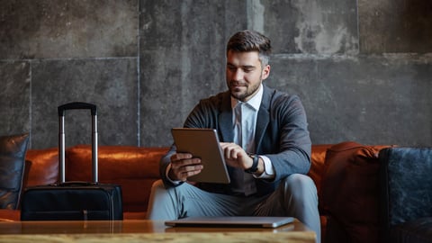 Man using laptop in hotel