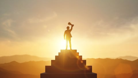 Businessman holding trophy