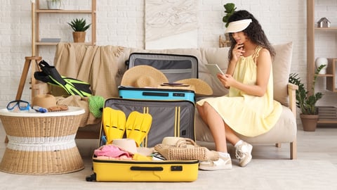 woman with unpacked luggage at hotel