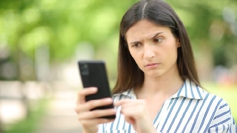 frustrated woman using AI on iphone 