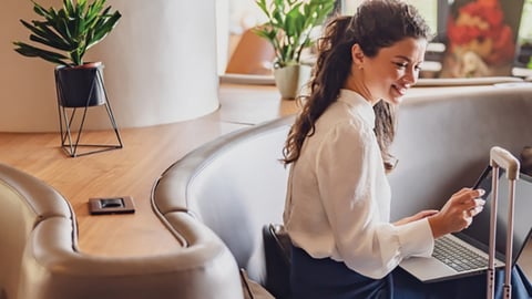 woman in hotel lobby with laptop