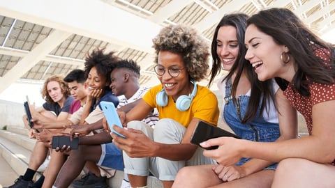 Group of young mixed race people with mobile phones. Excited students using their technological devices. Concept of young enterprising, friendly, selfie, app, hipster, millennial.; Shutterstock ID 2146917703