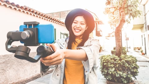 Happy asian woman vlogging with gimbal tripod and smartphone - Influencer chinese girl having fun with new trend technology - Millennial generation activity job, youth and tech concept - Focus on face; Shutterstock ID 1290378877