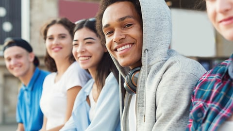 Multiethnic teen company spending time together, sitting outdoor, free space; Shutterstock ID 1403962730