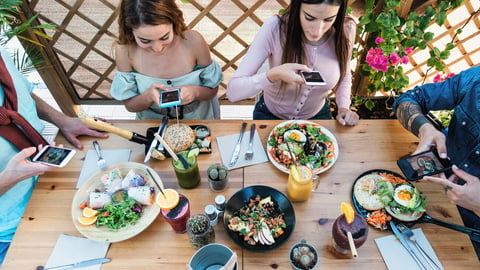 Young people taking food pictures with mobile smartphone to share on social media while having healthy meal in bar restaurant - Youth generation z and technology concept; Shutterstock ID 1940858899