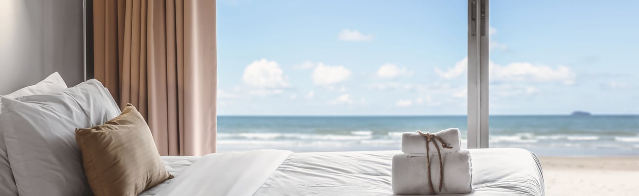 a large bed sitting next to a window