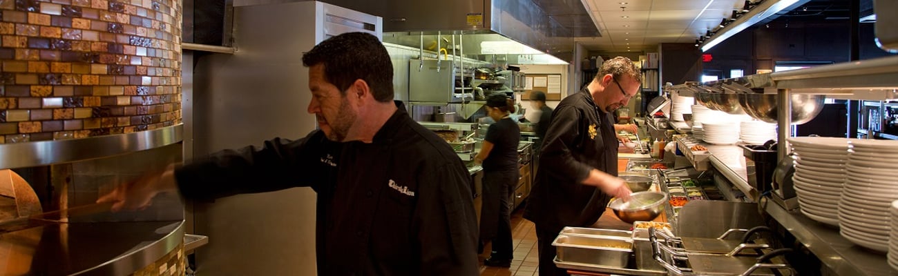 a man cooking in a kitchen preparing food