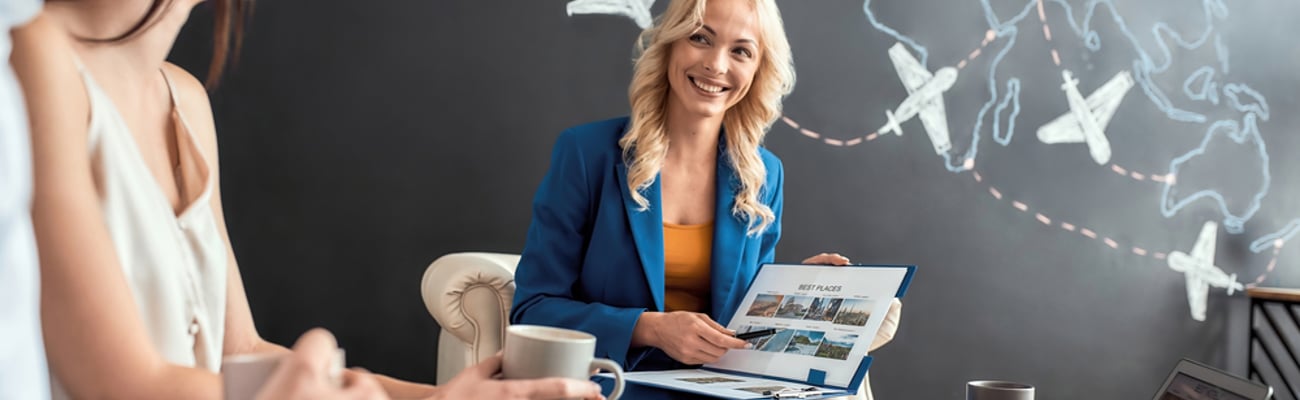 travel agent working with a couple to make vacation plans