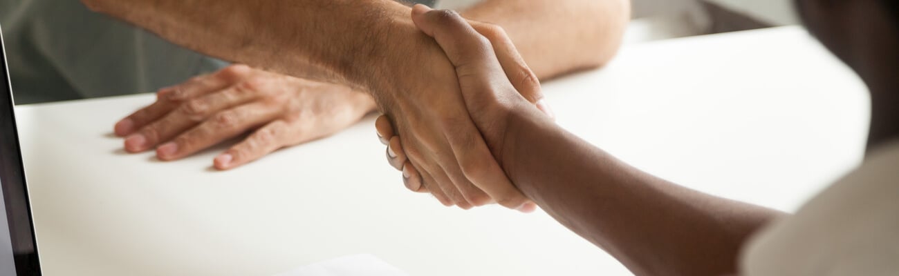 Employment handshake or making good first impression at successful interview concept, african employer and caucasian employee shake hands, black recruiter welcoming new white job candidate, close up; Shutterstock ID 1017665212