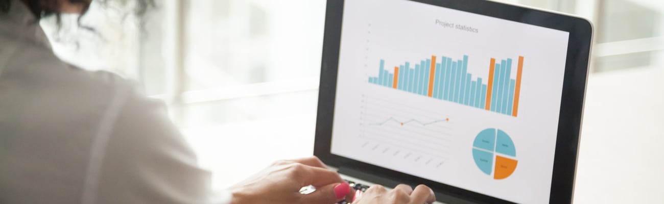 African businesswoman analyzing statistics on laptop screen, working with financial graphs charts online, using business software for data analysis and project management concept, rear close up view; Shutterstock ID 1022439592